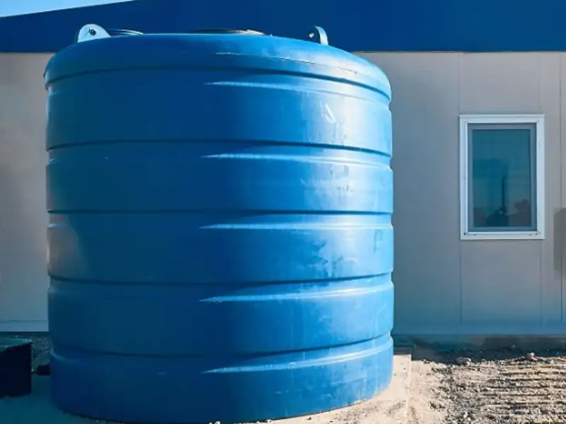 Plastic overhead water tank on an Indore rooftop ready for cleaning